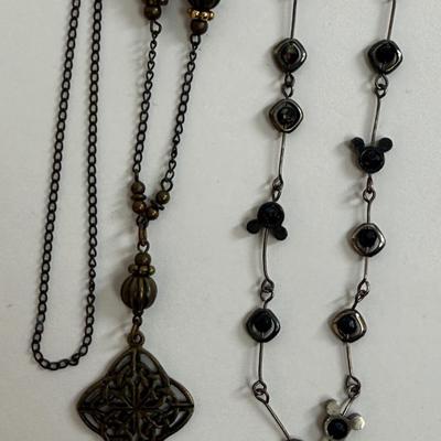 Sale Photo Thumbnail #389: Brassy 28" necklace with diamond-shaped open lattice pendant, and a Disney Mickey Mouse icon 15" necklace with a black and gold finish.