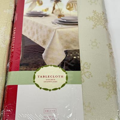 LOT 121: 4 NIP Oblong Golden Plaid and Snowflake Table Cloths