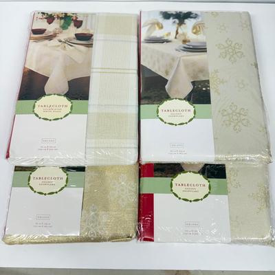 LOT 121: 4 NIP Oblong Golden Plaid and Snowflake Table Cloths