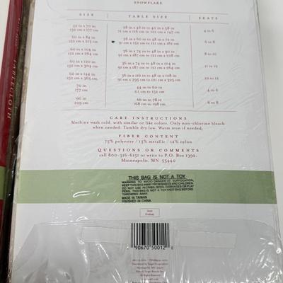 LOT 121: 4 NIP Oblong Golden Plaid and Snowflake Table Cloths