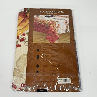 LOT 122: Four NIP Round Tablecloths