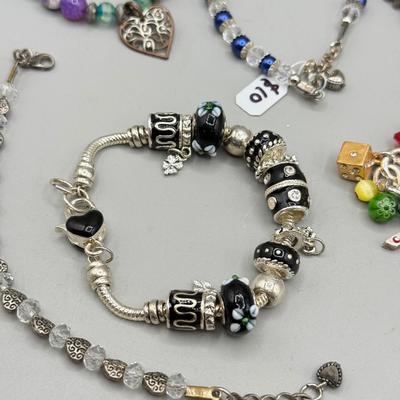 LOT 172: Collection of Charm & Beaded Bracelets