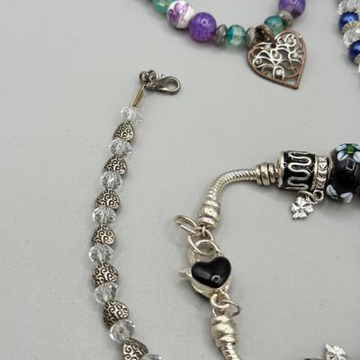 LOT 172: Collection of Charm & Beaded Bracelets