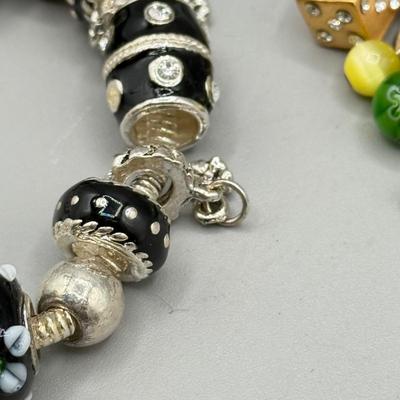 LOT 172: Collection of Charm & Beaded Bracelets