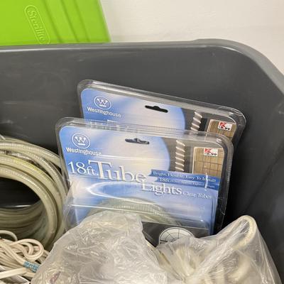 LOT 175: Tote full of White Tube & Red String Lights and a new Gemmy LED Lightshow Projection WHIRL-A-MOTION, heavy duty large tote...