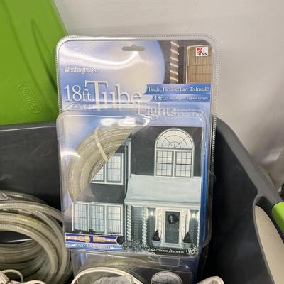 LOT 175: Tote full of White Tube & Red String Lights and a new Gemmy LED Lightshow Projection WHIRL-A-MOTION, heavy duty large tote...