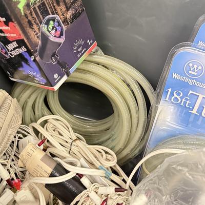 LOT 175: Tote full of White Tube & Red String Lights and a new Gemmy LED Lightshow Projection WHIRL-A-MOTION, heavy duty large tote...