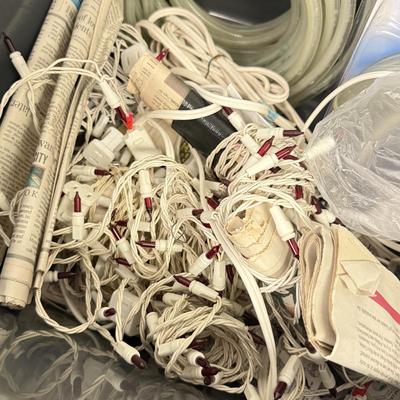 LOT 175: Tote full of White Tube & Red String Lights and a new Gemmy LED Lightshow Projection WHIRL-A-MOTION, heavy duty large tote...