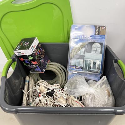 LOT 175: Tote full of White Tube & Red String Lights and a new Gemmy LED Lightshow Projection WHIRL-A-MOTION, heavy duty large tote...