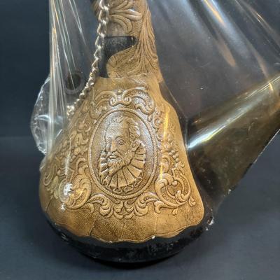 LOT 87: Vintage Hand-Blown Green Glass Wine Decanter & Leather Covered Embossed Spanish Wine Decanter along with Romania Arcadia Crystal