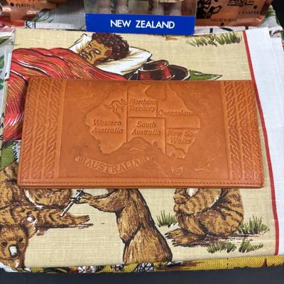 LOT 96: Australia Souvenirs: Copper Faced Clock, Table Linens, Tea Towels, Embossed Wallet, Key Holder