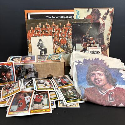 LOT 102: Vintage Philadelphia Flyers Memorabilia: T-shirts, Trading Cards, Team Photos, Stanley Cup Magazine along with a Box of Mixed...