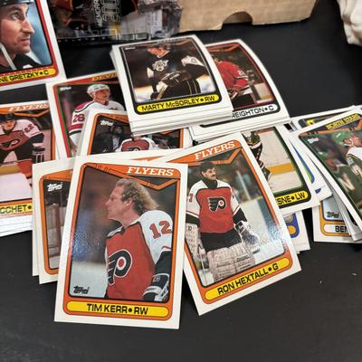 LOT 102: Vintage Philadelphia Flyers Memorabilia: T-shirts, Trading Cards, Team Photos, Stanley Cup Magazine along with a Box of Mixed...