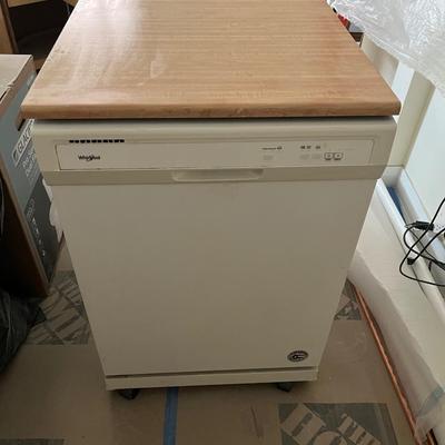 Sale Photo Thumbnail #151: Portable whirlpool dishwasher that has wheels and can be freely rolled around your cooking space.  The top is a flat surface that can be used as counter space.  
Power cable and hose are both on the back of the unit and retract into the unit when not in u