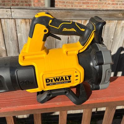 Sale Photo Thumbnail #165: Portable 20V Dewalt weed trimmer and leaf blower set.  The weed trimmer folds into itself for easier storage and charging station for the battery (not shown) comes with the set.