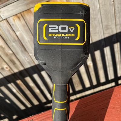 Sale Photo Thumbnail #164: Portable 20V Dewalt weed trimmer and leaf blower set.  The weed trimmer folds into itself for easier storage and charging station for the battery (not shown) comes with the set.