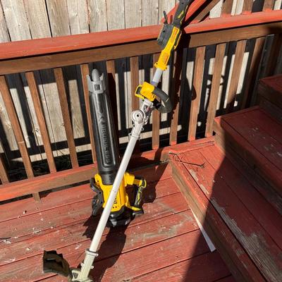 Sale Photo Thumbnail #163: Portable 20V Dewalt weed trimmer and leaf blower set.  The weed trimmer folds into itself for easier storage and charging station for the battery (not shown) comes with the set.