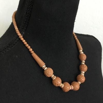 Vintage lucite plastic carved bead with barrel clasp