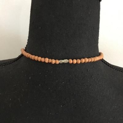 Vintage lucite plastic carved bead with barrel clasp