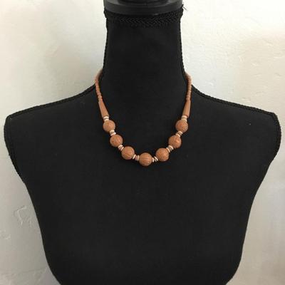 Vintage lucite plastic carved bead with barrel clasp