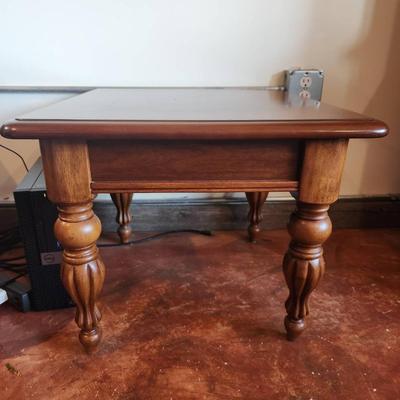 Sale Photo Thumbnail #33: Cherry wood side table featuring turned legs and a decorative inlay on the tabletop. Measures 2 feet in height, 1.6 feet in width, and 2 feet in depth. The table showcases a rich wood grain and classic craftsmanship, ideal for functional or decorative pur