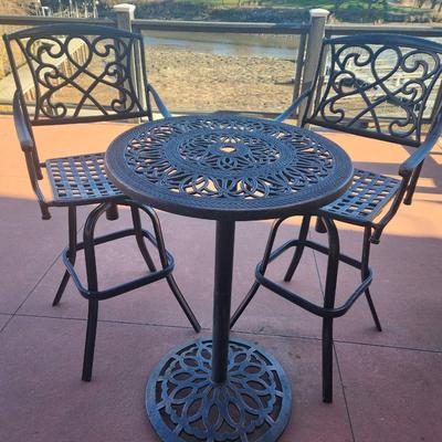Sale Photo Thumbnail #146: Outdoor bistro set featuring a round table and two armchairs, crafted from cast aluminum with intricate patterns. The table and chairs exhibit matching openwork designs with scroll and floral motifs. The set is durable and weather-resistant, suitable for 