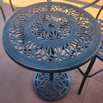 Sale Photo Thumbnail #147: Outdoor bistro set featuring a round table and two armchairs, crafted from cast aluminum with intricate patterns. The table and chairs exhibit matching openwork designs with scroll and floral motifs. The set is durable and weather-resistant, suitable for 