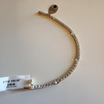 Sale Photo Thumbnail #12: This auction lot is for a Sterling Silver Tennis Bracelet.  The bracelet is new and still sports the maker's tags. It is marked 925. The bracelet has for very light blue stones with raised metal sections between each stone. A very handsome item of jewelry