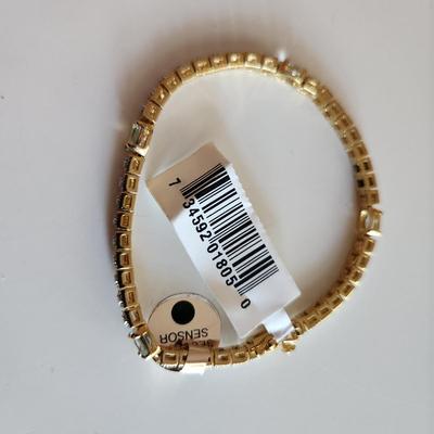 Sale Photo Thumbnail #9: This auction lot is for a Sterling Silver Tennis Bracelet.  The bracelet is new and still sports the maker's tags. It is marked 925. The bracelet has for very light blue stones with raised metal sections between each stone. A very handsome item of jewelry