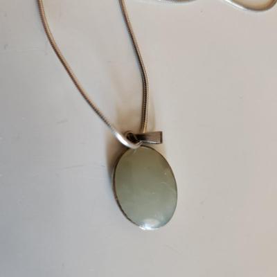 Sale Photo Thumbnail #34: This auction lot is for Four Sterling Silver Necklaces. Three necklace are marked 925.  There is a 16-inch necklace with a large cut glass stone, another 14-inch necklace with a pendant of silver overlay on jade stone, a very delicate 17-inch chain with a