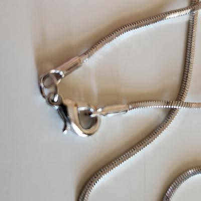 Sale Photo Thumbnail #28: This auction lot is for Four Sterling Silver Necklaces. Three necklace are marked 925.  There is a 16-inch necklace with a large cut glass stone, another 14-inch necklace with a pendant of silver overlay on jade stone, a very delicate 17-inch chain with a