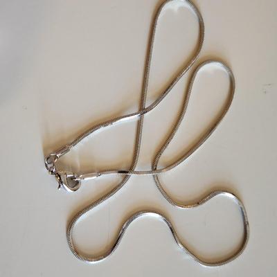 Sale Photo Thumbnail #26: This auction lot is for Four Sterling Silver Necklaces. Three necklace are marked 925.  There is a 16-inch necklace with a large cut glass stone, another 14-inch necklace with a pendant of silver overlay on jade stone, a very delicate 17-inch chain with a