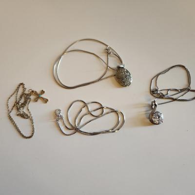 Sale Photo Thumbnail #37: This auction lot is for Four Sterling Silver Necklaces. Three necklace are marked 925.  There is a 16-inch necklace with a large cut glass stone, another 14-inch necklace with a pendant of silver overlay on jade stone, a very delicate 17-inch chain with a