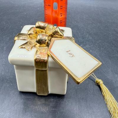 Sale Photo Thumbnail #439: Shaped like a Christmas present tied with a 24K Gold Plated ribbon and bow. Good condition, approx. 3.5” tall.