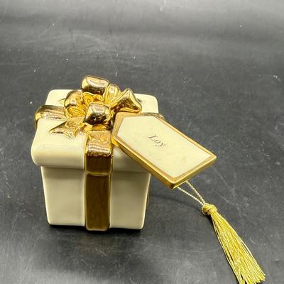 Sale Photo Thumbnail #438: Shaped like a Christmas present tied with a 24K Gold Plated ribbon and bow. Good condition, approx. 3.5” tall.