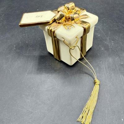 Sale Photo Thumbnail #441: Shaped like a Christmas present tied with a 24K Gold Plated ribbon and bow. Good condition, approx. 3.5” tall.