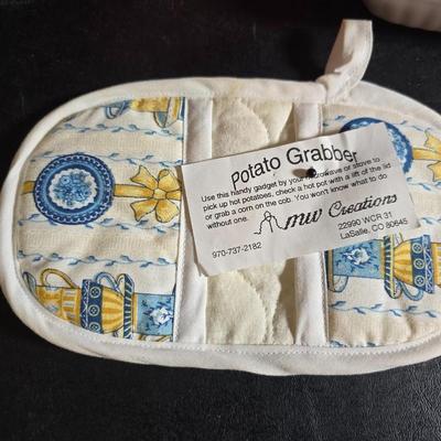 Oven and microwave safe Stoneware dishes with an assortment of themed basket cloths, small cookbooks, and a red pepper salsa dish