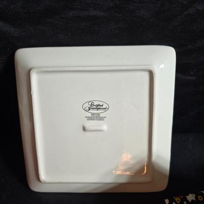 Oven and microwave safe Stoneware dishes with an assortment of themed basket cloths, small cookbooks, and a red pepper salsa dish