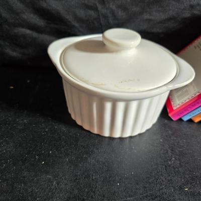 Oven and microwave safe Stoneware dishes with an assortment of themed basket cloths, small cookbooks, and a red pepper salsa dish
