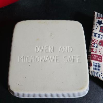 Oven and microwave safe Stoneware dishes with an assortment of themed basket cloths, small cookbooks, and a red pepper salsa dish