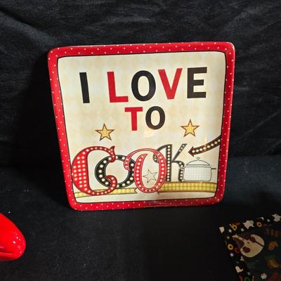 Oven and microwave safe Stoneware dishes with an assortment of themed basket cloths, small cookbooks, and a red pepper salsa dish