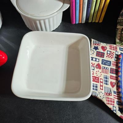 Oven and microwave safe Stoneware dishes with an assortment of themed basket cloths, small cookbooks, and a red pepper salsa dish