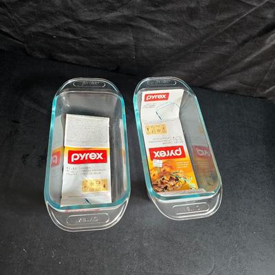 Two glass pyrex cake pans, two new glass Pyrex bread loaf pans and a nice cookie sheet