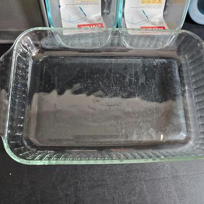Two glass pyrex cake pans, two new glass Pyrex bread loaf pans and a nice cookie sheet