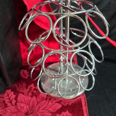 Keurig coffee maker with pod caddy - a red apron - and several Christmas themed mugs.