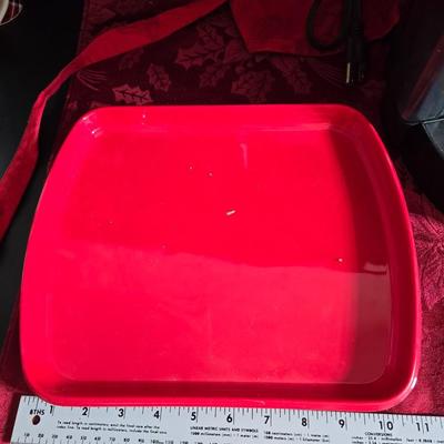 Keurig coffee maker with pod caddy - a red apron - and several Christmas themed mugs.