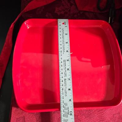 Keurig coffee maker with pod caddy - a red apron - and several Christmas themed mugs.