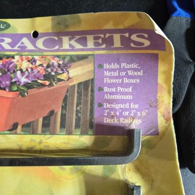 Two brand new deck brackets - a nice sprinkler - work gloves and a Polaroid digital picture frame with outdoor temperature display