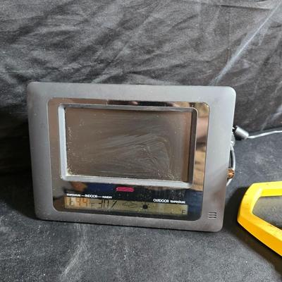 Two brand new deck brackets - a nice sprinkler - work gloves and a Polaroid digital picture frame with outdoor temperature display