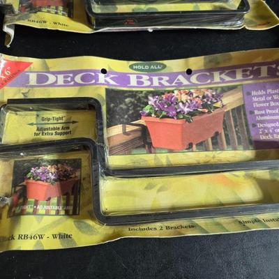 Two brand new deck brackets - a nice sprinkler - work gloves and a Polaroid digital picture frame with outdoor temperature display